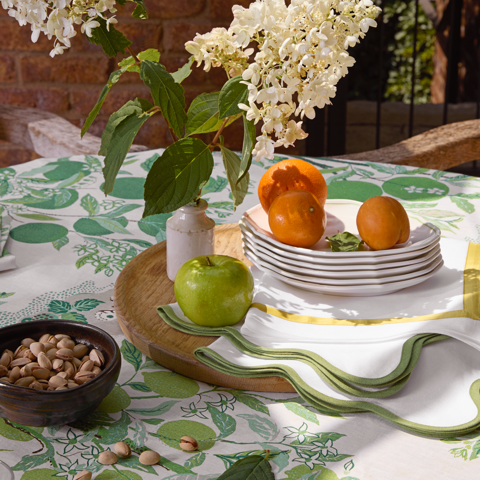 Matouk Schumacher Citrus Garden Table Linens in Grass Color with Fruits