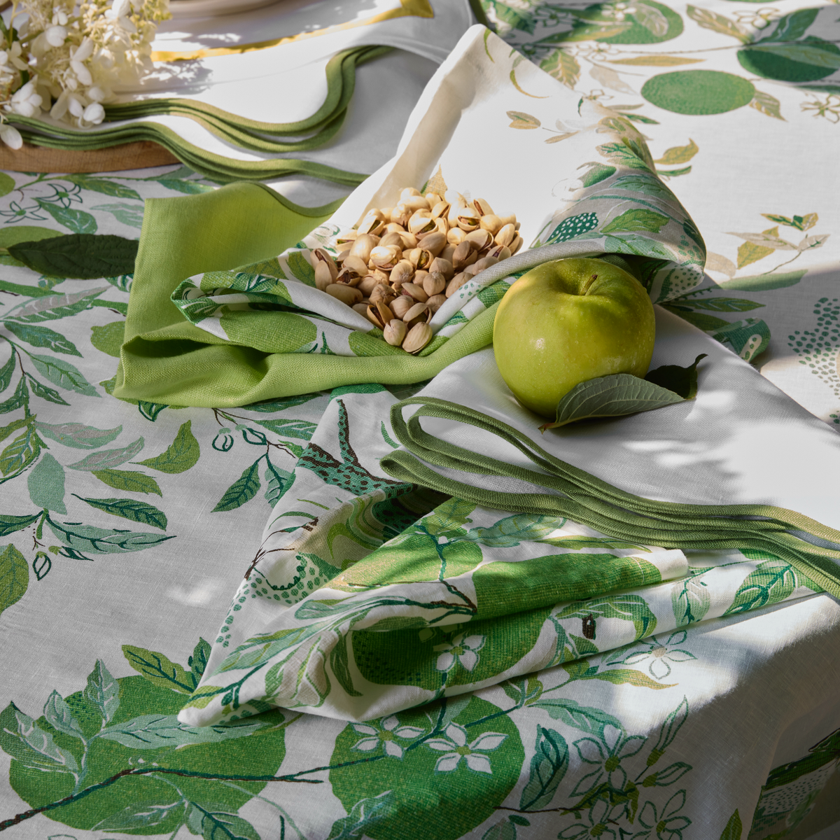 Closeup of Matouk Schumacher Citrus Garden Table Linens in Grass Color