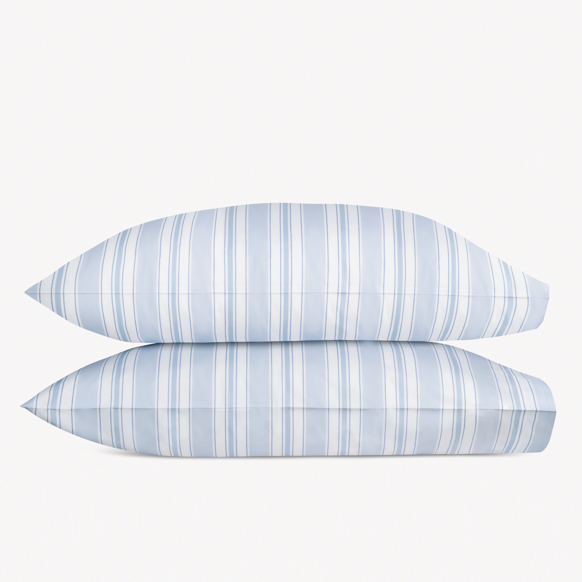 Two stacked pillows from the Mocha Matouk Schumacher Elio Collection in Blue color