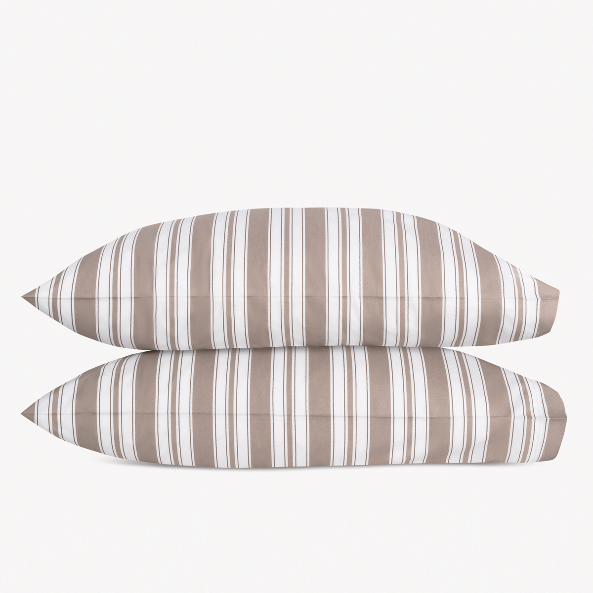 Two stacked pillows from the Mocha Matouk Schumacher Elio Collection in Mocha color