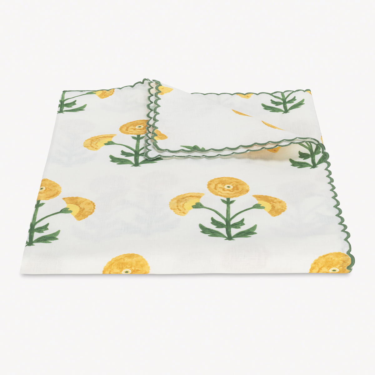 Folded Tablecloth of Matouk Schumacher Gisele Table Linens in Marigold