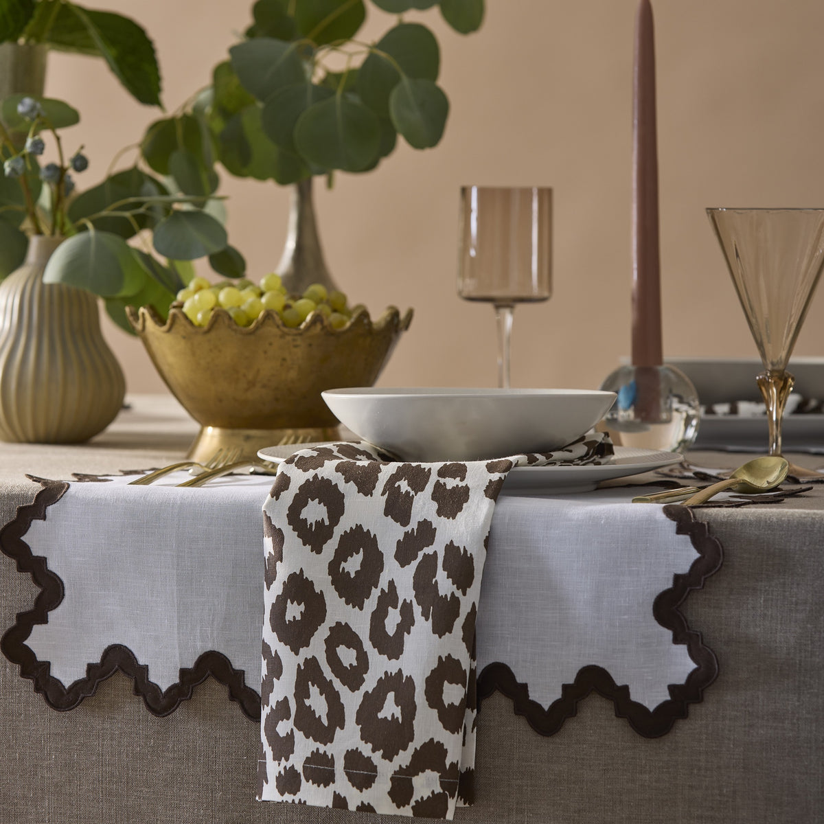 Lifestyle Shot of Matouk Schumacher Iconic Leopard Table Napkin in Cinder Color