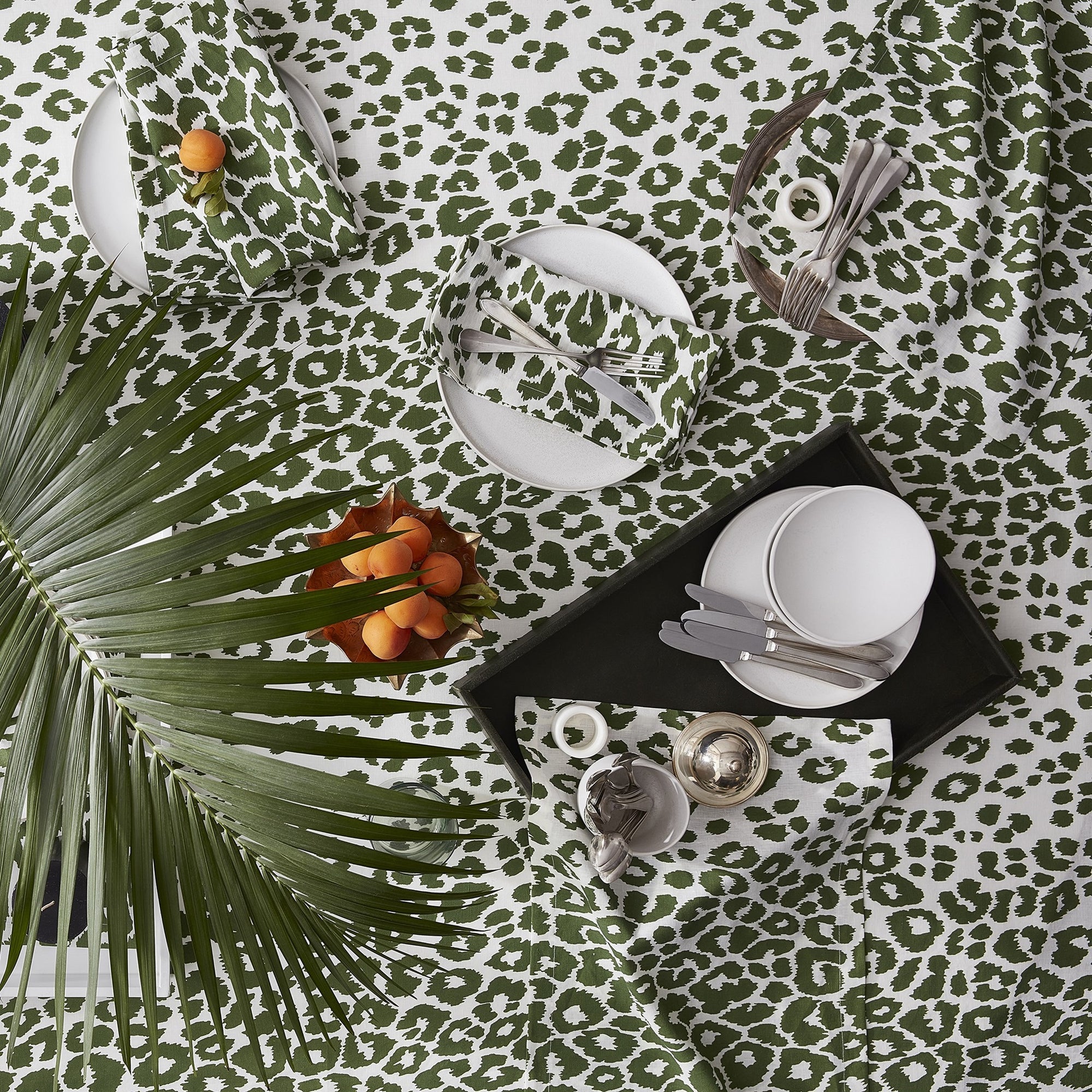 Lifestyle Shot of Matouk Schumacher Iconic Leopard Table Linens in Green Color