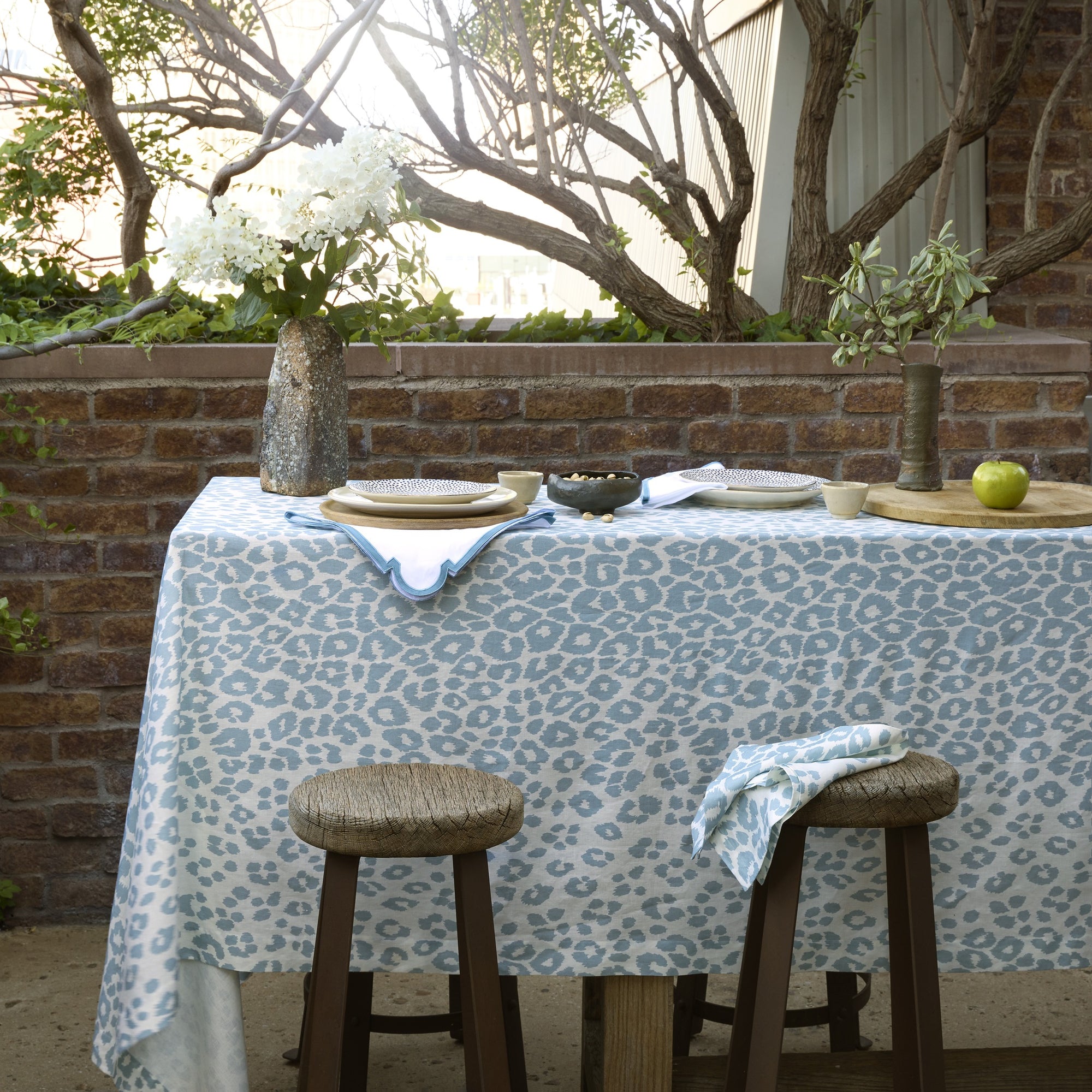 Lifestyle Shot of Matouk Schumacher Iconic Leopard Table Linens in Sky Color