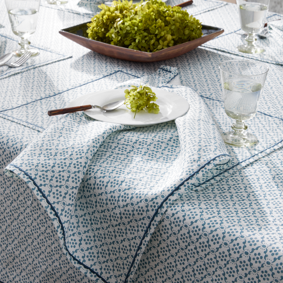 Table arranged with Matouk Schumacher Laksha Table Linens in Lapis color