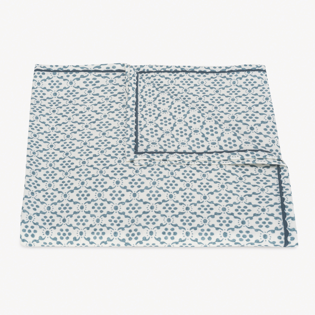 Folded Tablecloth of Matouk Schumacher Laksha Table Linens in Lapis color
