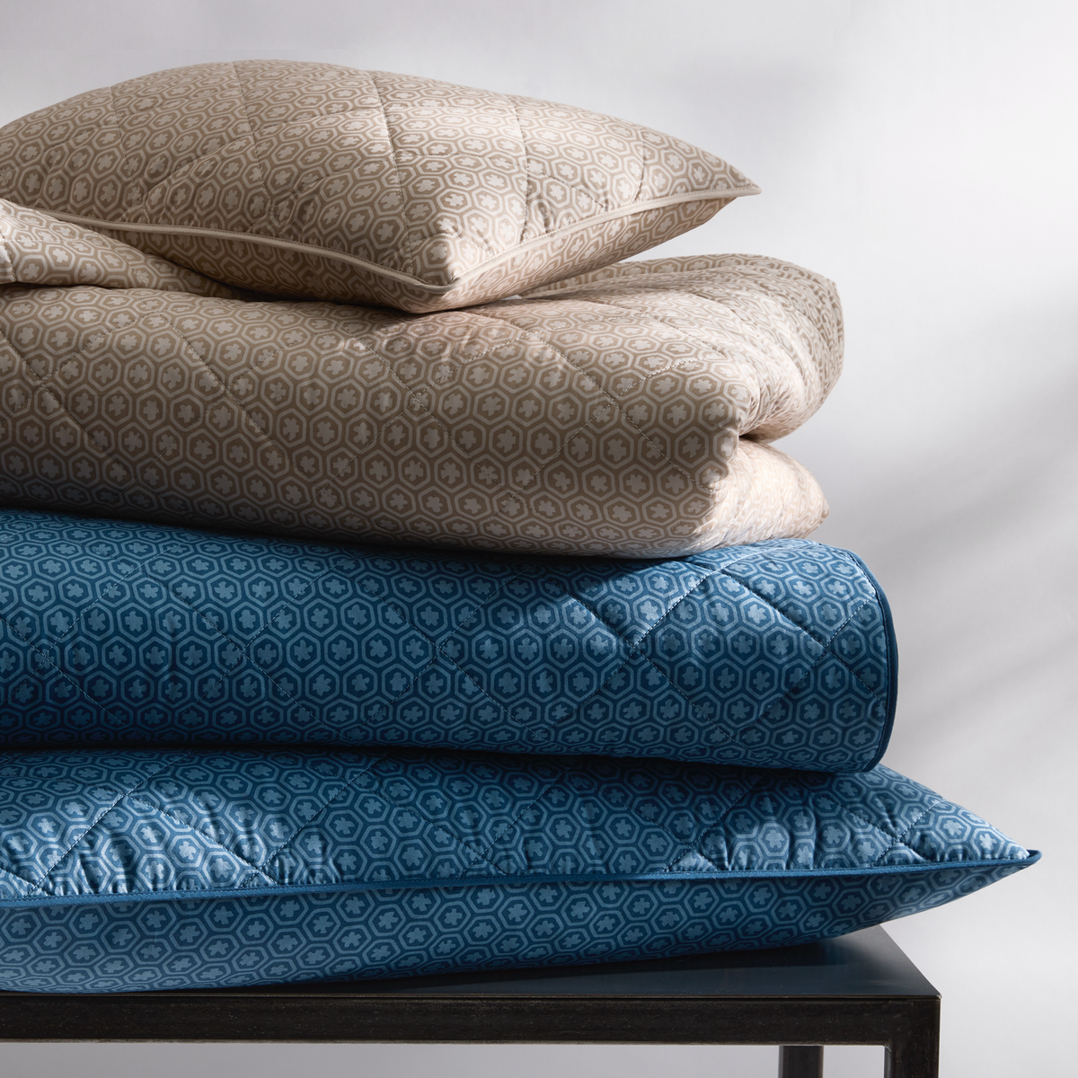 Stack of Quilted Matouk Schumacher Levi Bedding in Both Colors