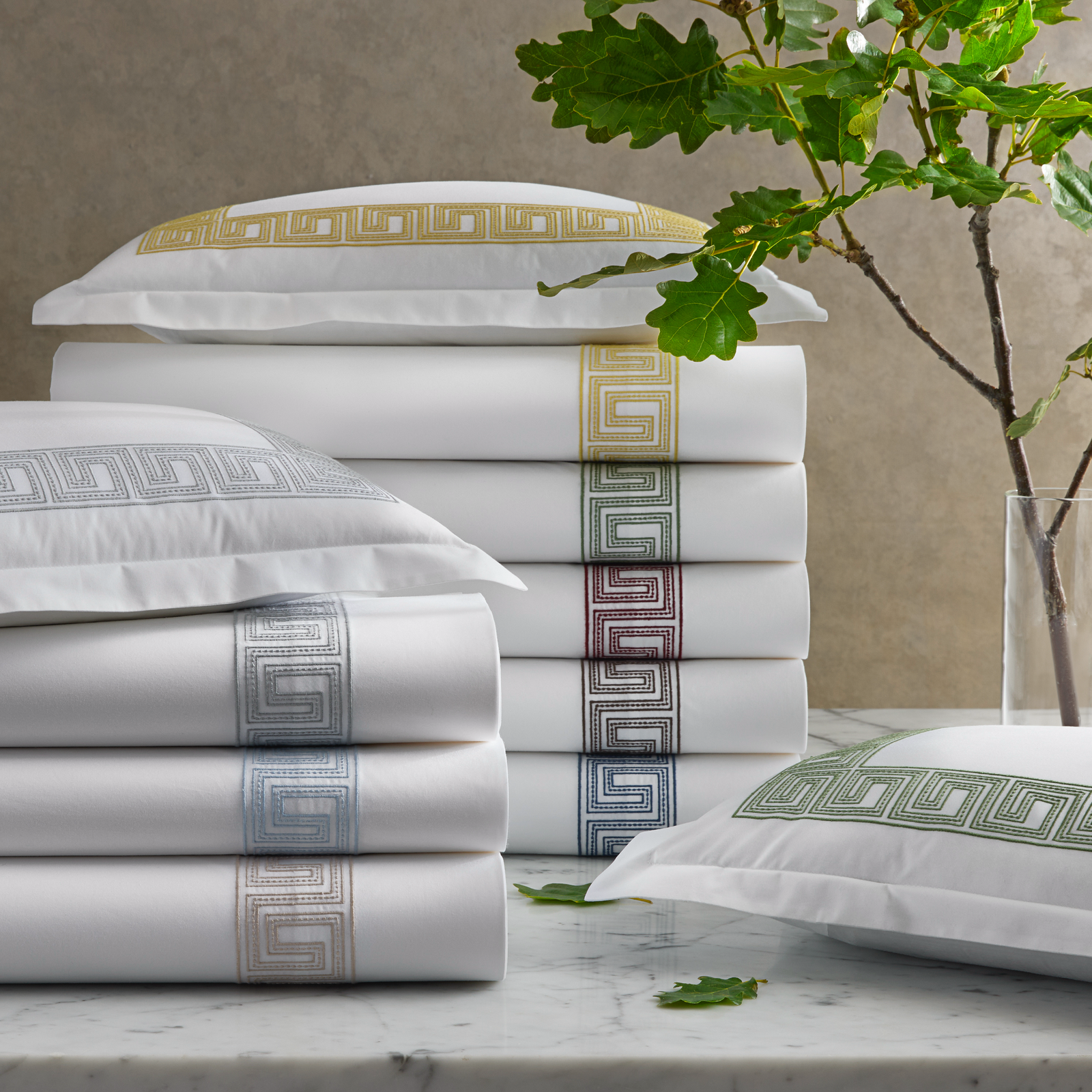 Stack of Matouk Schumacher Ophelia Bedding in All Colors