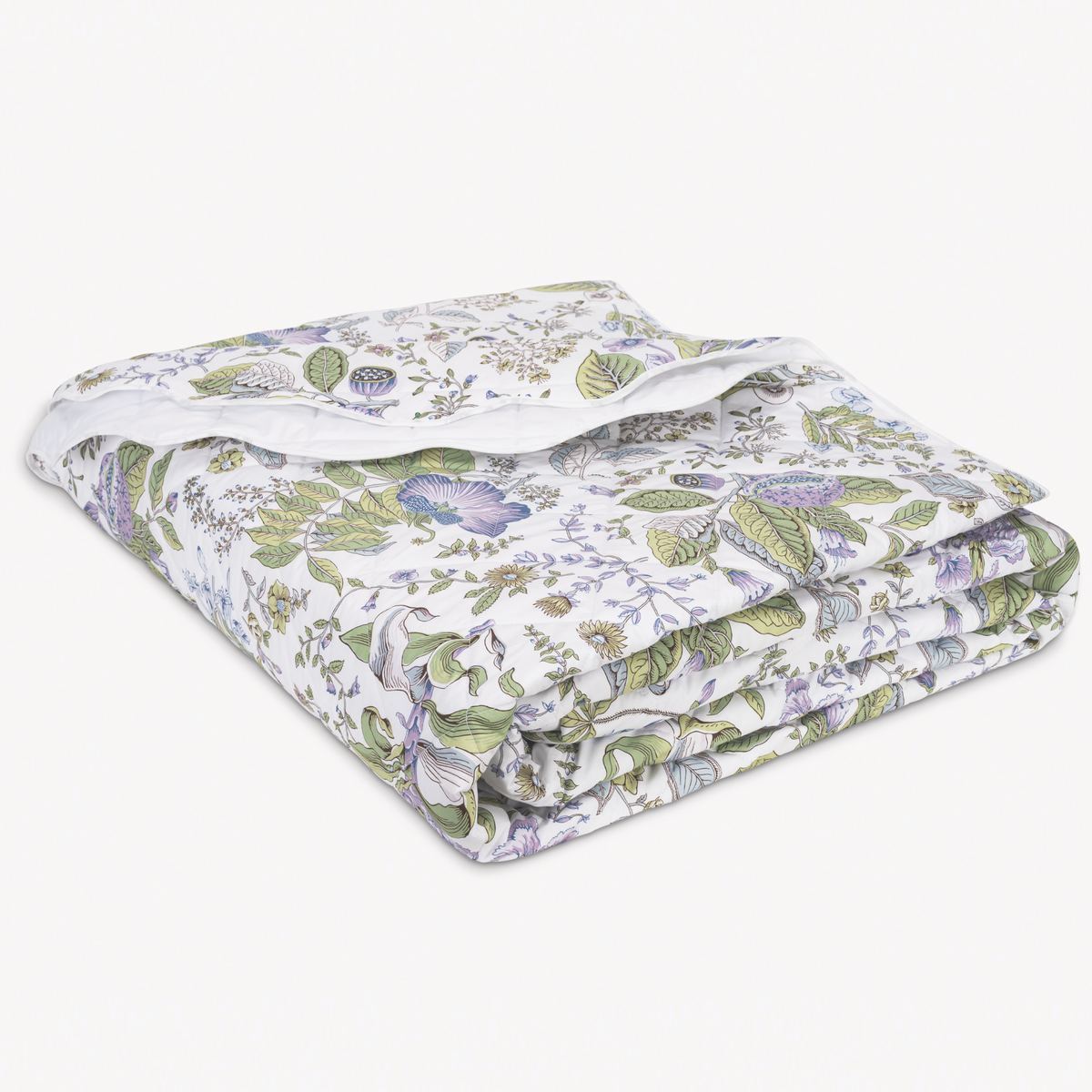 A folded Quilt Blanket in Schumacher Matouk pomegranate bedding Lilac pattern