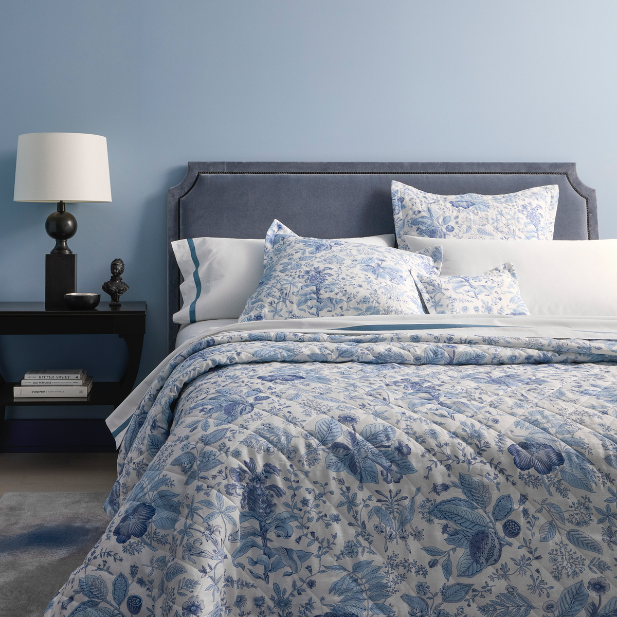 Lifestyle Picture of Corner Full Bed of Matouk Schumacher Pomegranate Linen Bedding in Porcelain Blue Color