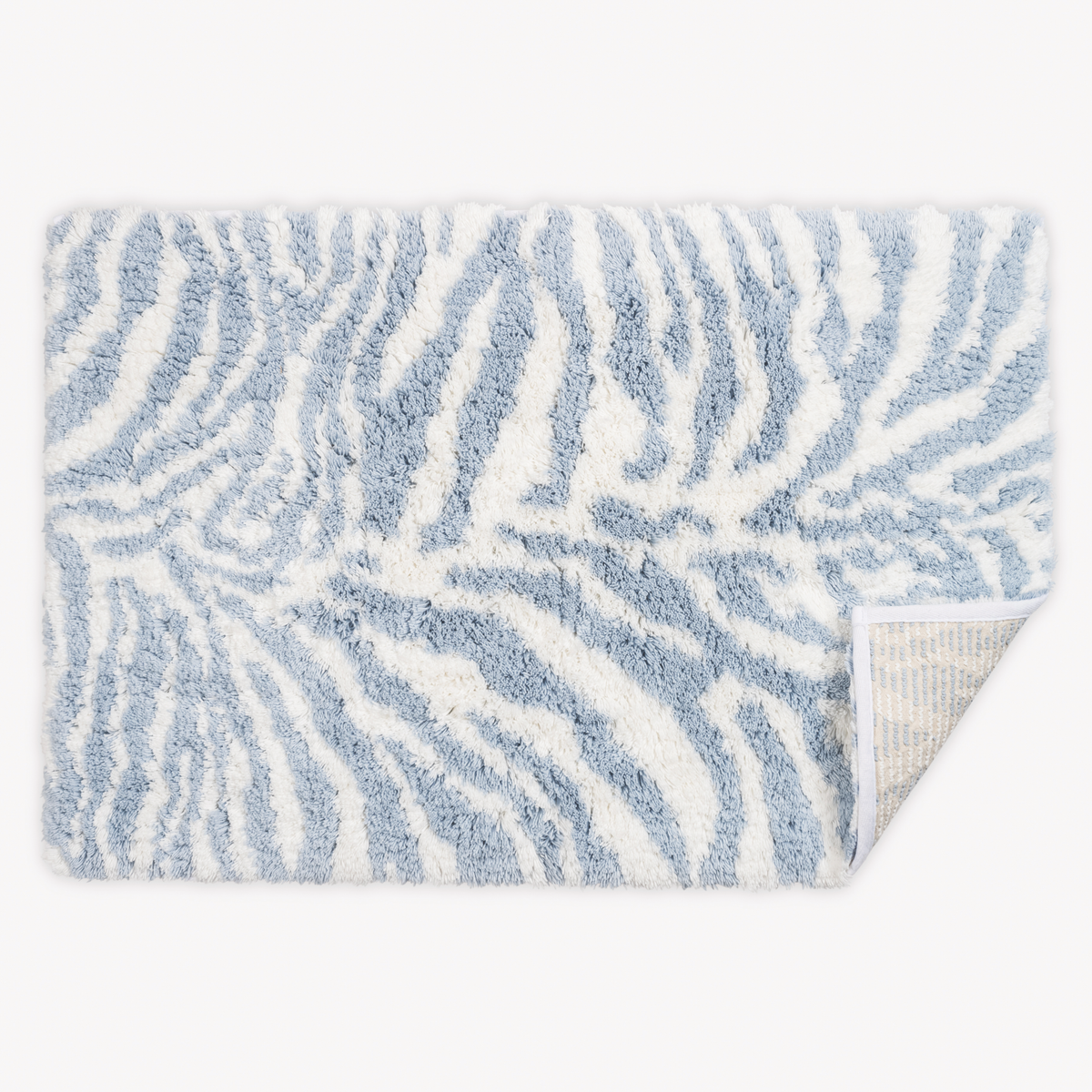 Top view of Matouk Schumacher Regine Bath Rugs in Hydrangea color with one tip folded