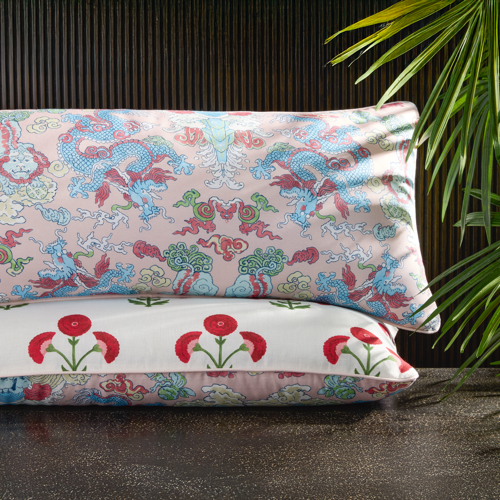 Stack of Matouk Schumacher Reversible Pillow Collection in Gisele Scarlet/Magic Mountain Paradise