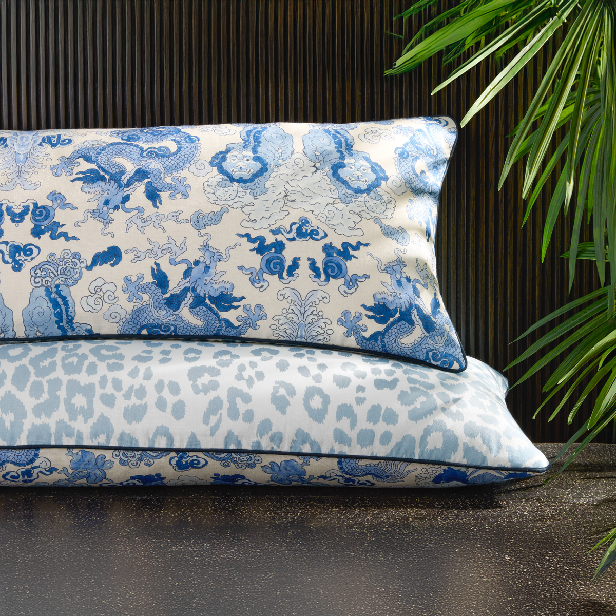 Stack of Matouk Schumacher Reversible Pillow Collection in Magic Mountain Porcelain Blue/Iconic Leopard Sky