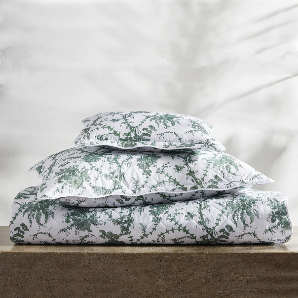 Stack of Quilted Matouk Schumacher San Cristobal Bedding in Green Color