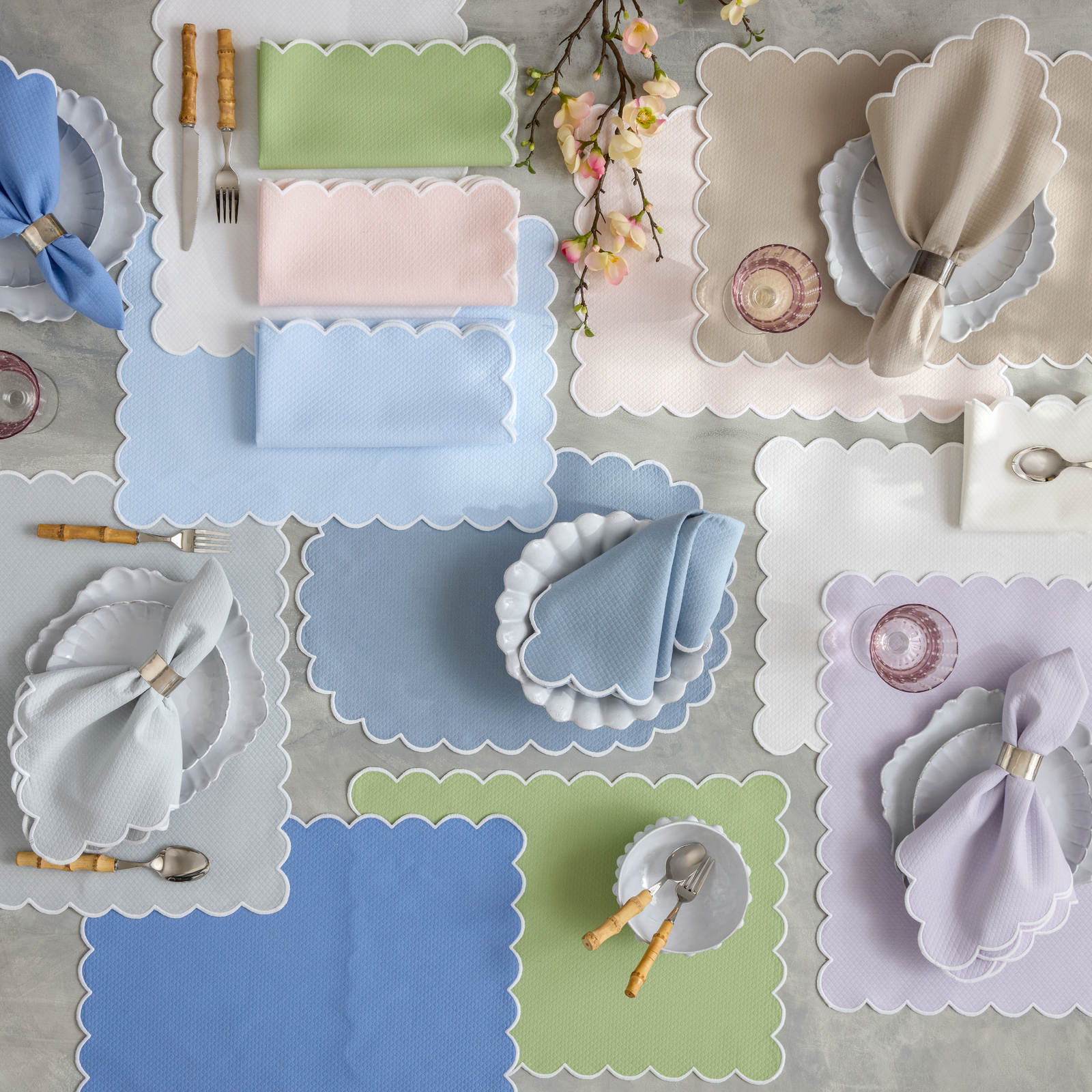 A table set with Matouk Savannah Gardens Table Linens napkins and placemats