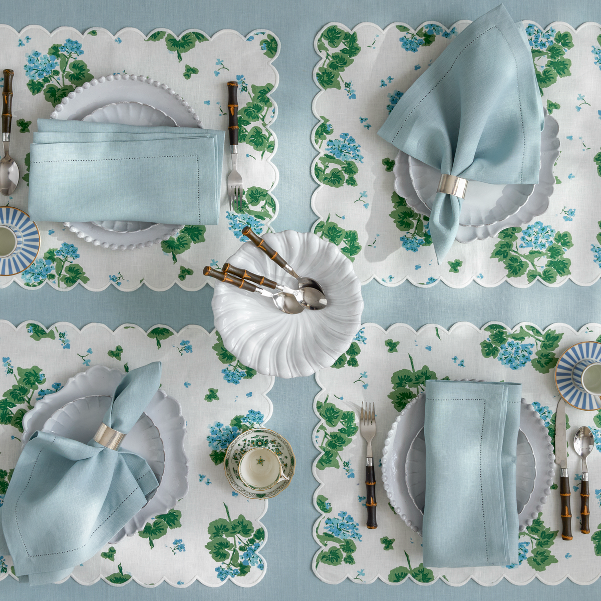 Matouk Geranium Table Linens in Blue shown with Valentina Hemstitch in Sky