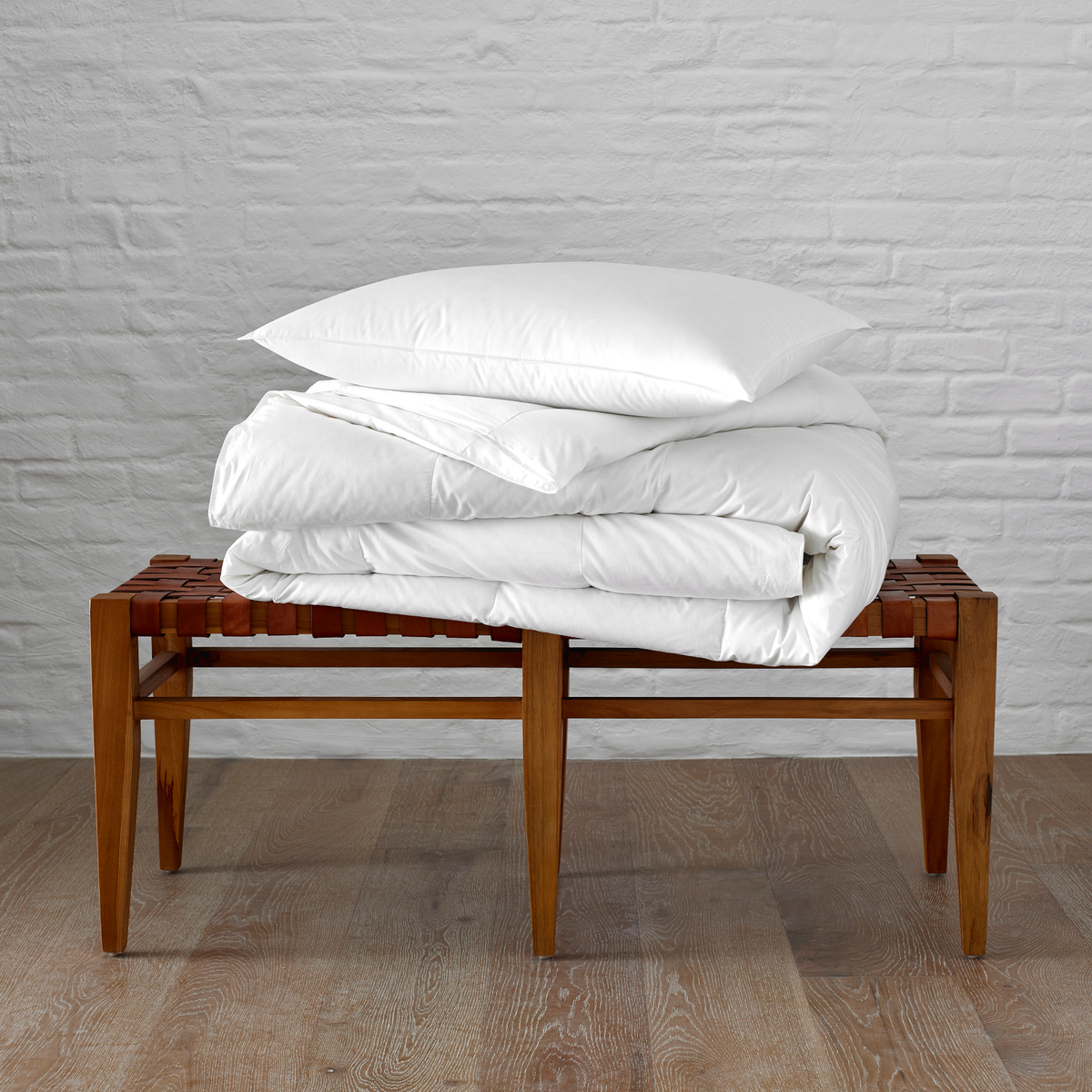 Stack of Matouk Valletto Pillow and Comforter