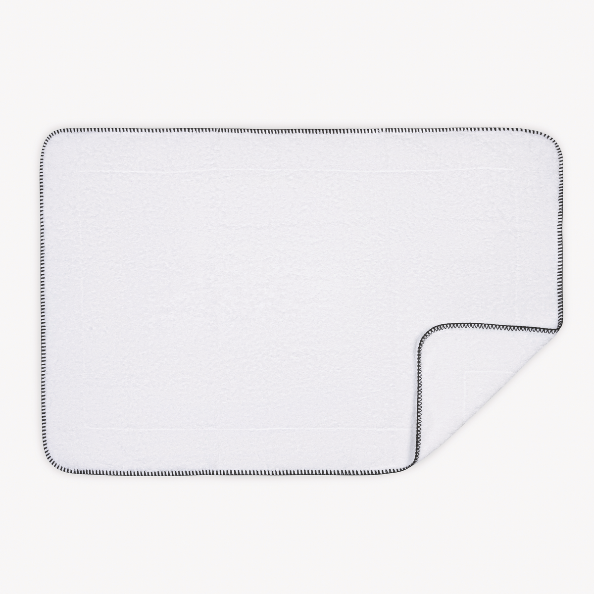 Tubmat of Black Matouk Whipstitch Bath Collection with folded corner
