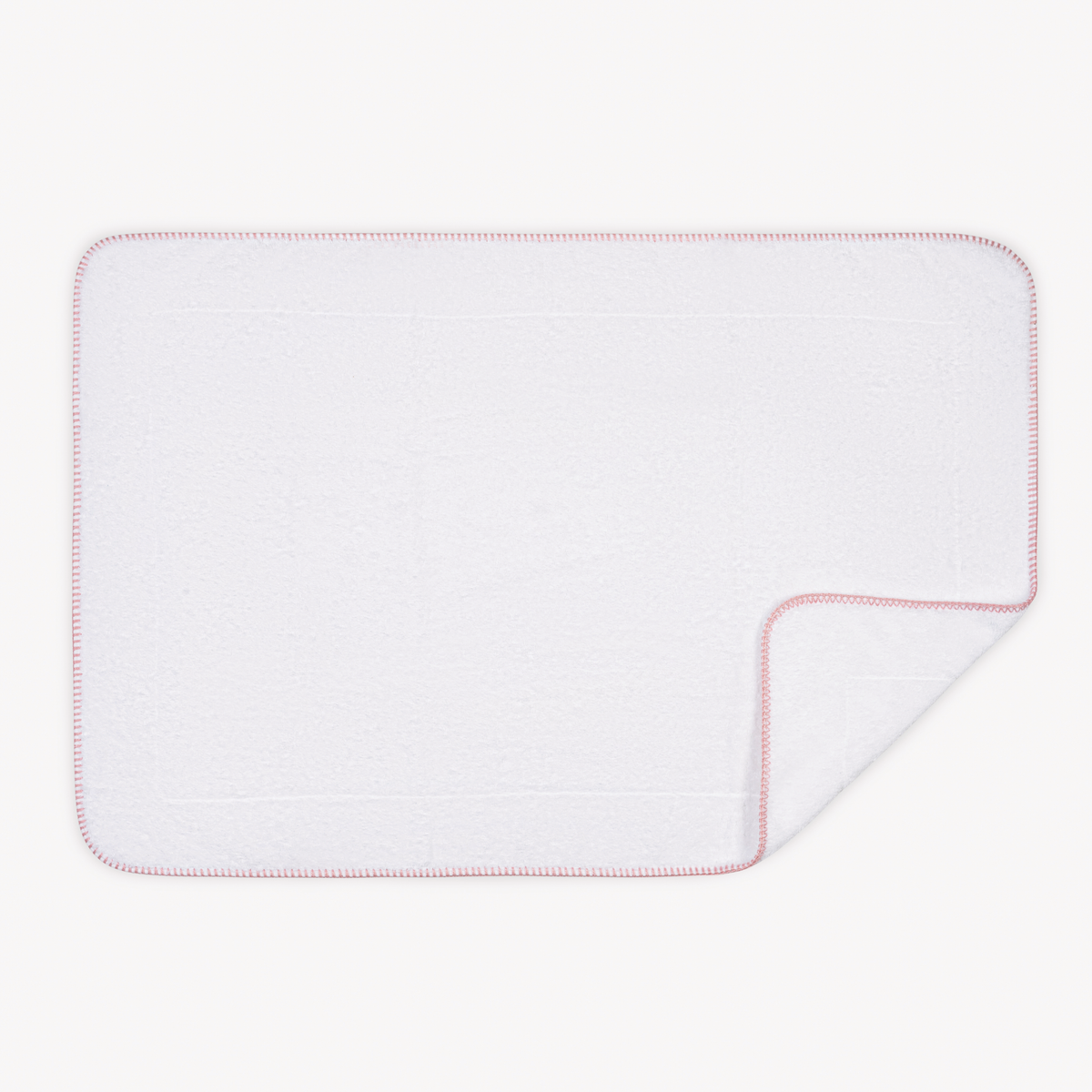 Tubmat of Carnation Matouk Whipstitch Bath Collection with folded corner
