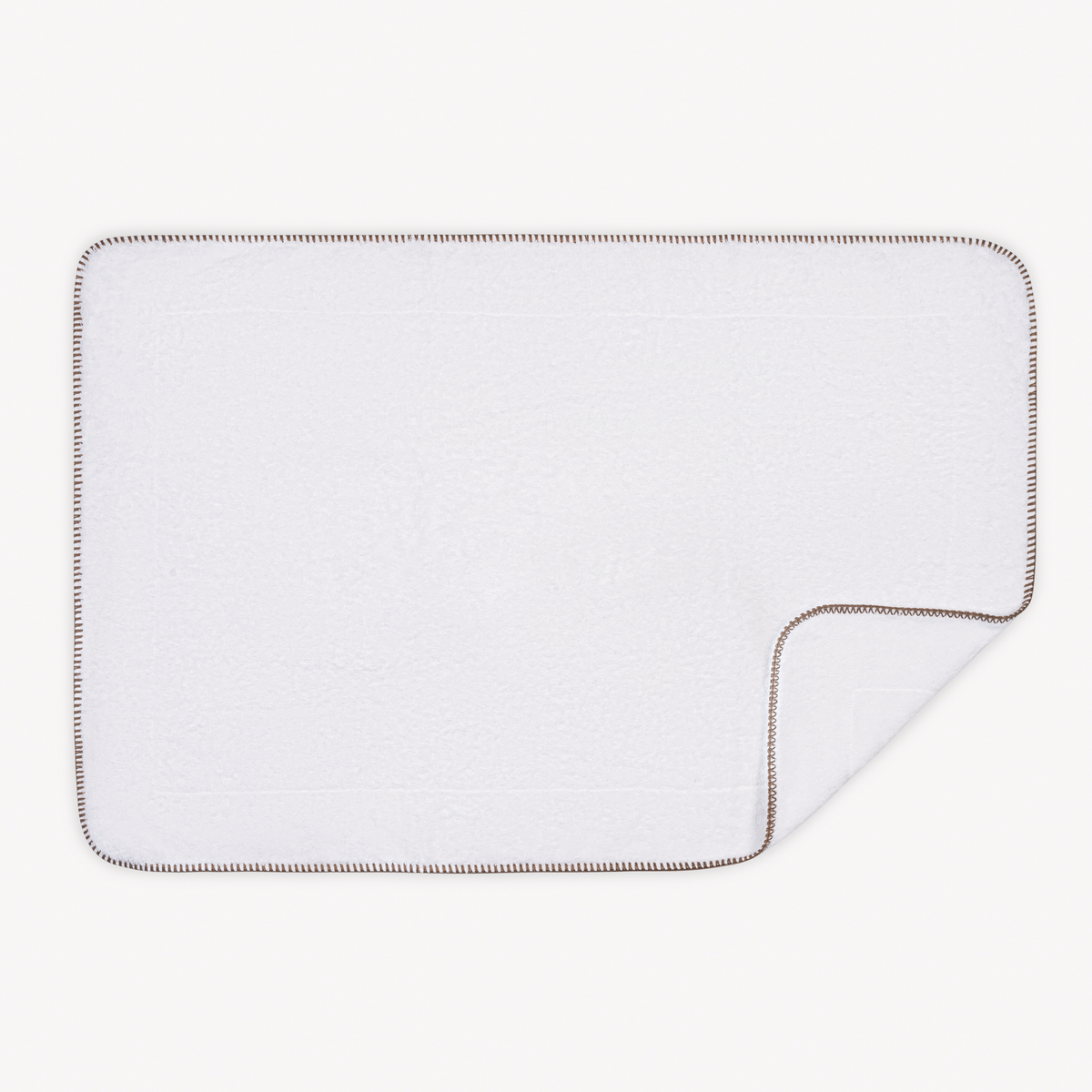 Tubmat of Cocoa Matouk Whipstitch Bath Collection with folded corner