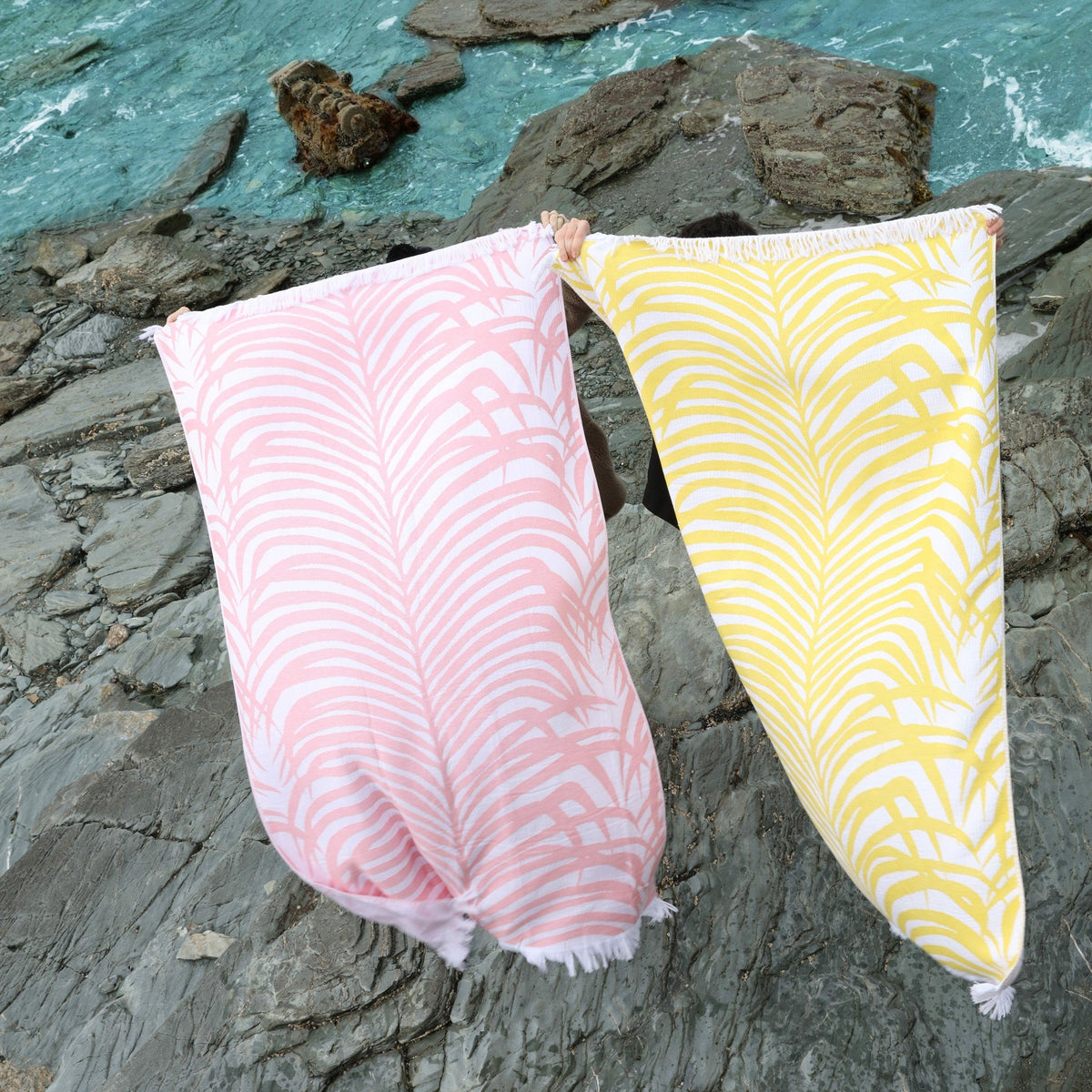 Matouk Zebra Palm Beach Towels in Color Flamingo and Canary by the Ocean