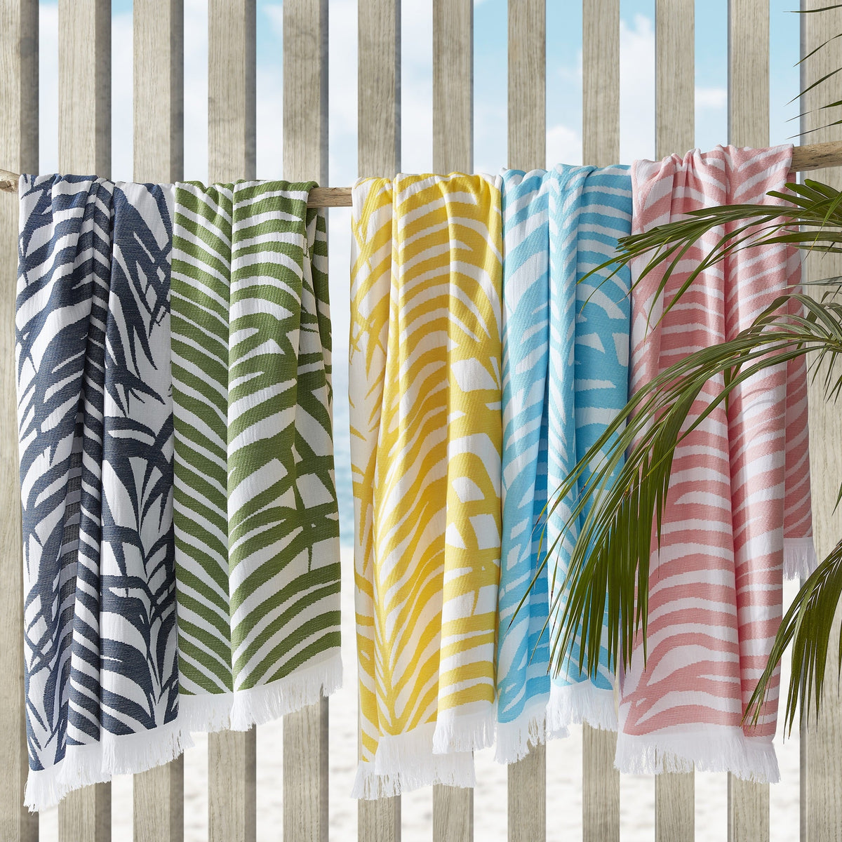 Hanging Matouk Zebra Palm Beach Towels in Different Colors