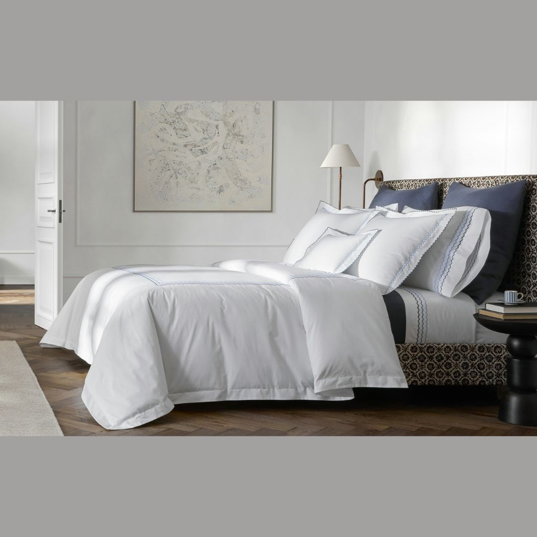 Matouk Axel Bedding in Azure with Dream Modal on a bed - hero image