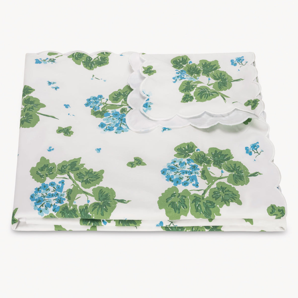 Floral-patterned duvet cover with green leaves and blue flowers on a white background