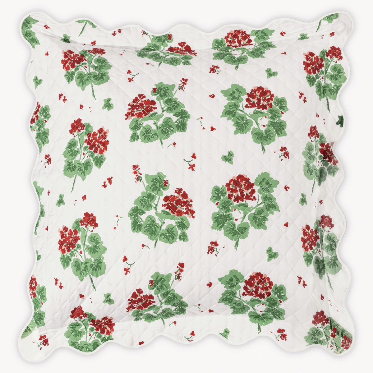 Floral patterned fabric with red flowers and green leaves on a white background