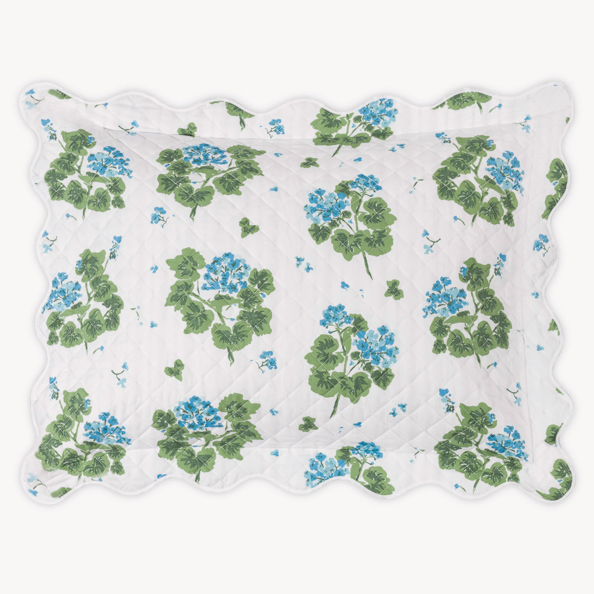 Floral patterned sham with green leaves and blue flowers on a white background