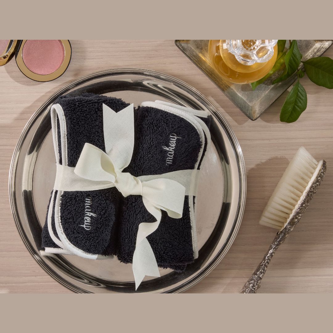 Matouk Giza Makeup Towel image on tray with makeup accessories