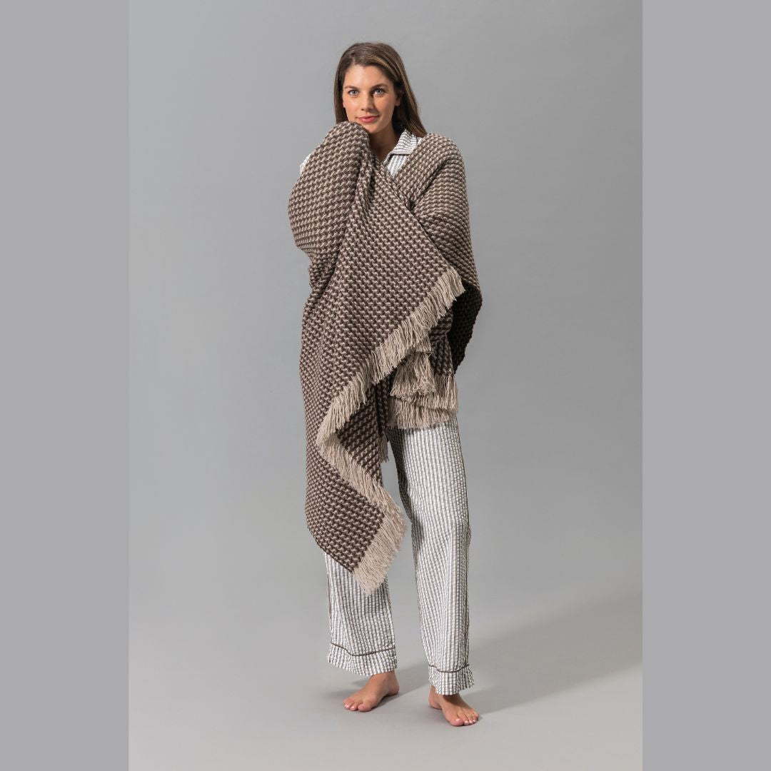 Matouk Matteo pajama in Bark and wrapped in Cleo Throw