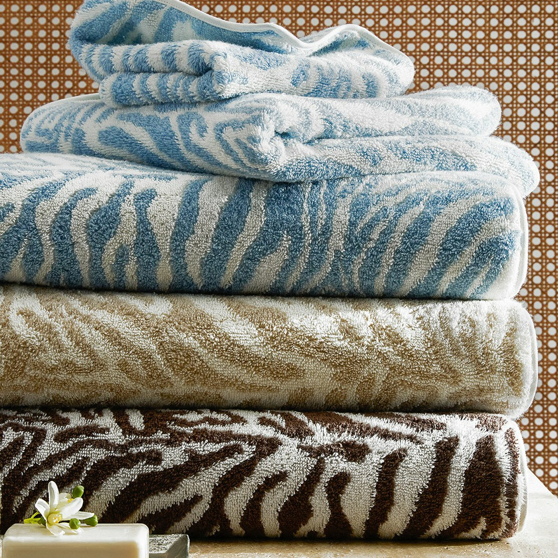 Matouk Regine Bath Towels in a stack - Hydrangea, Sand and Sable