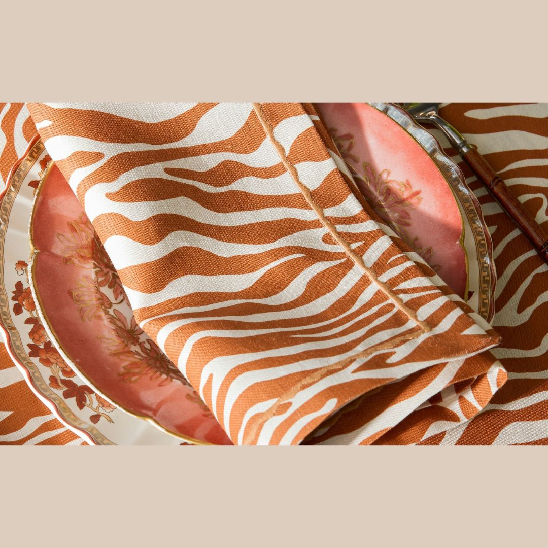 Matouk Schumacher Regine Table Linens in Persimmon with a table setting