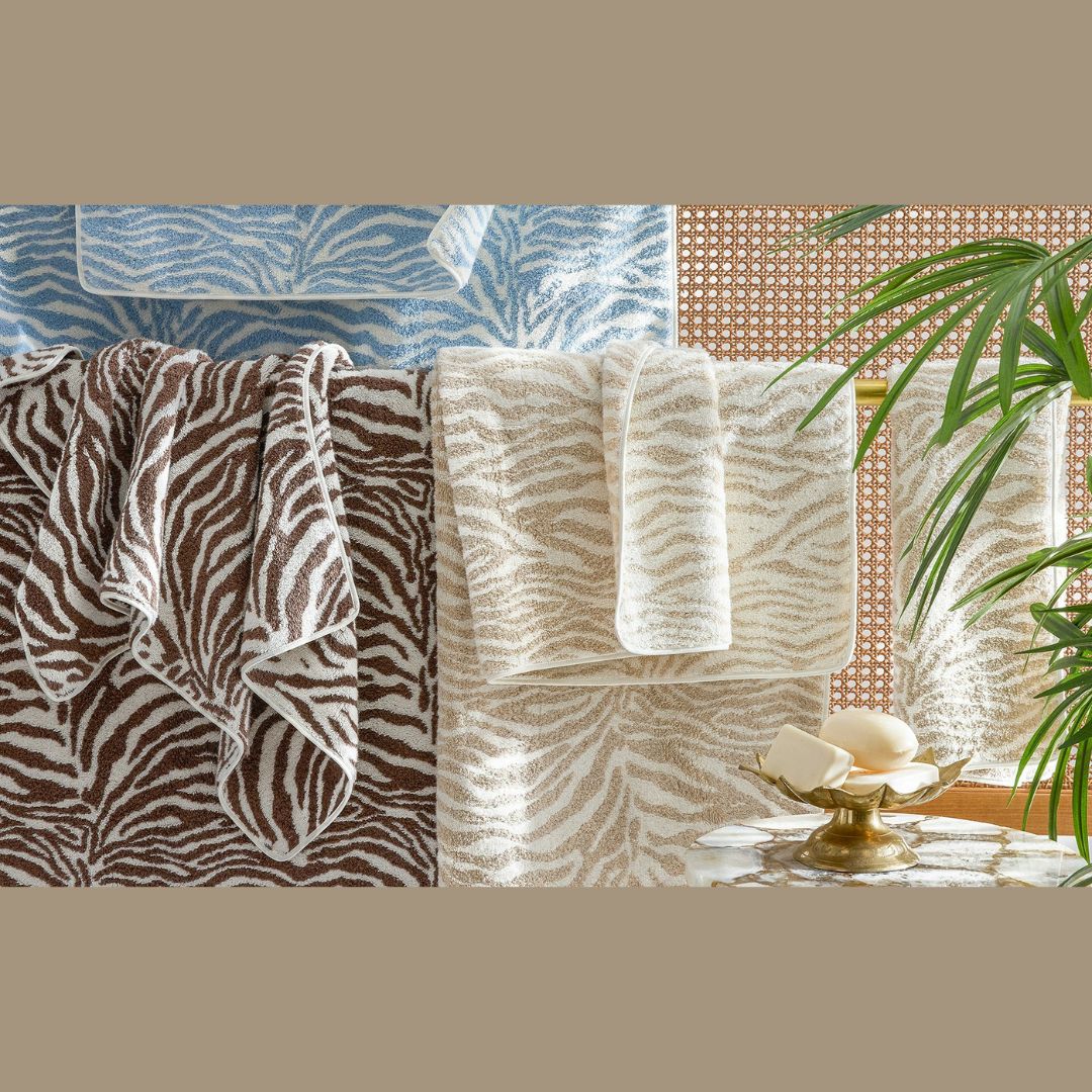 Matouk Regine Sable, Sand and Hydrangea towels hanging 