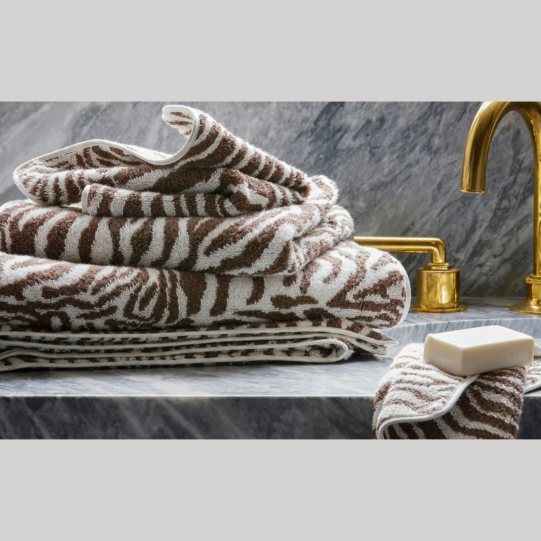 Matouk Regine Sable towels on a marble bathroom sink