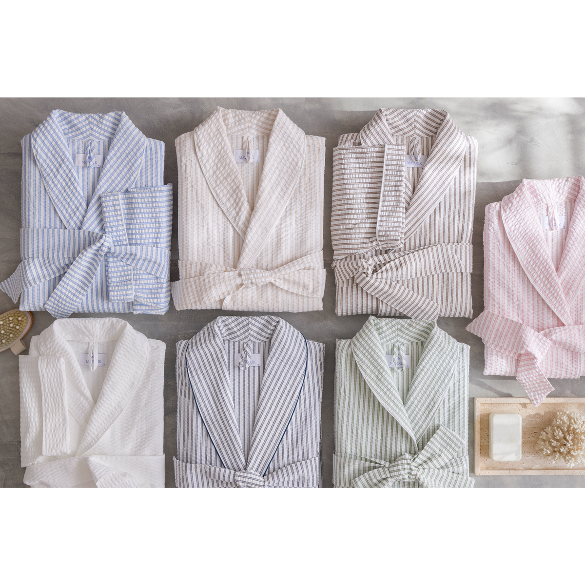 Matouk Matteo Robes in 2026 colors are arranged neatly on a light gray surface