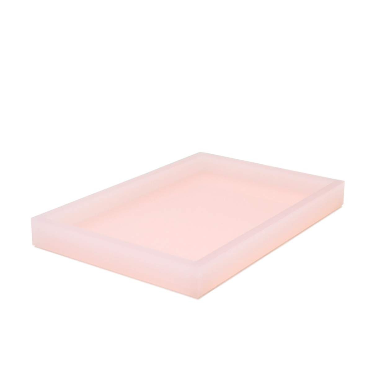 A rectangular, translucent pink tray with raised edges from our lucite collection, displayed on a white background.
