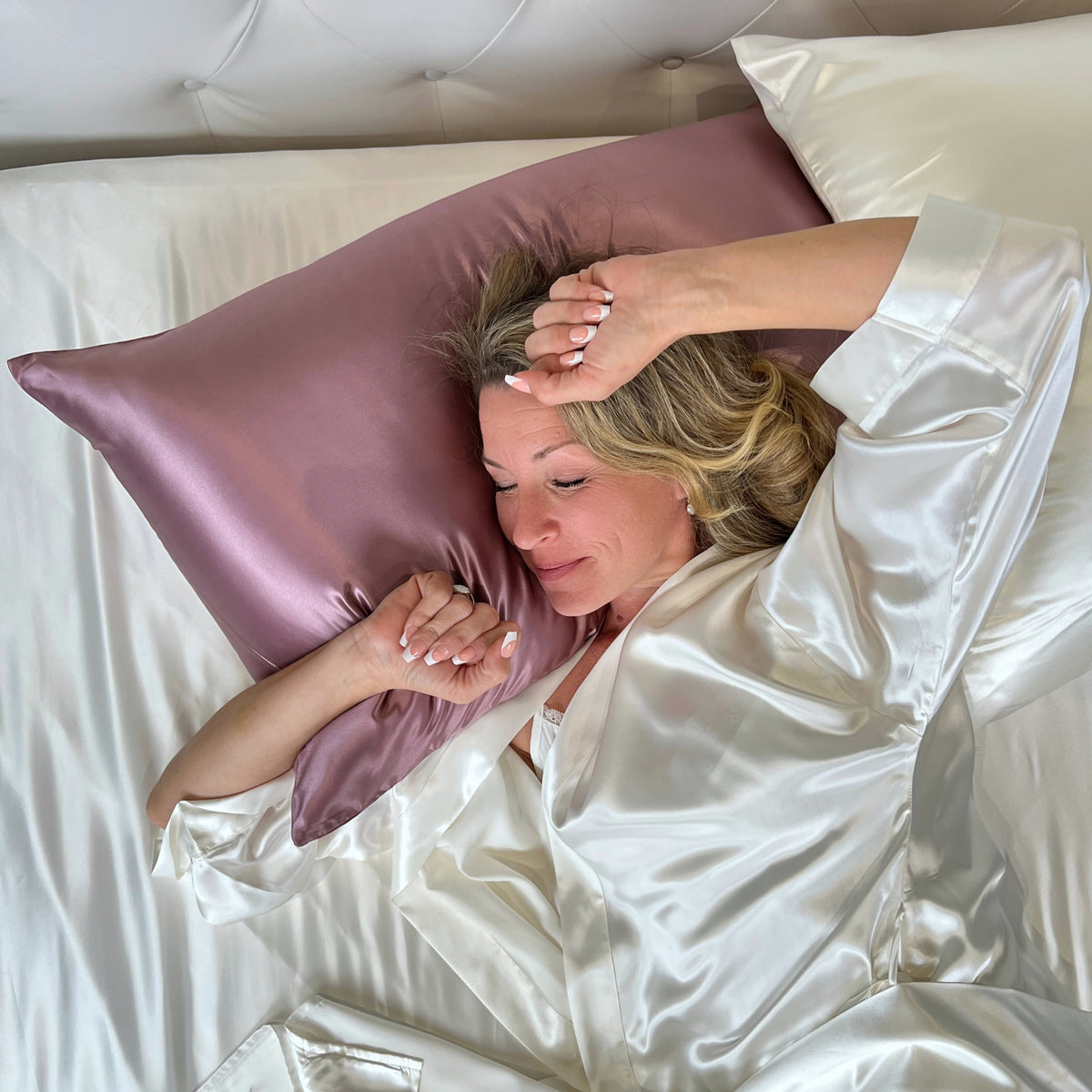Woman waking up in bed with soft sage sheet and sage pillowcase, feeling refreshed