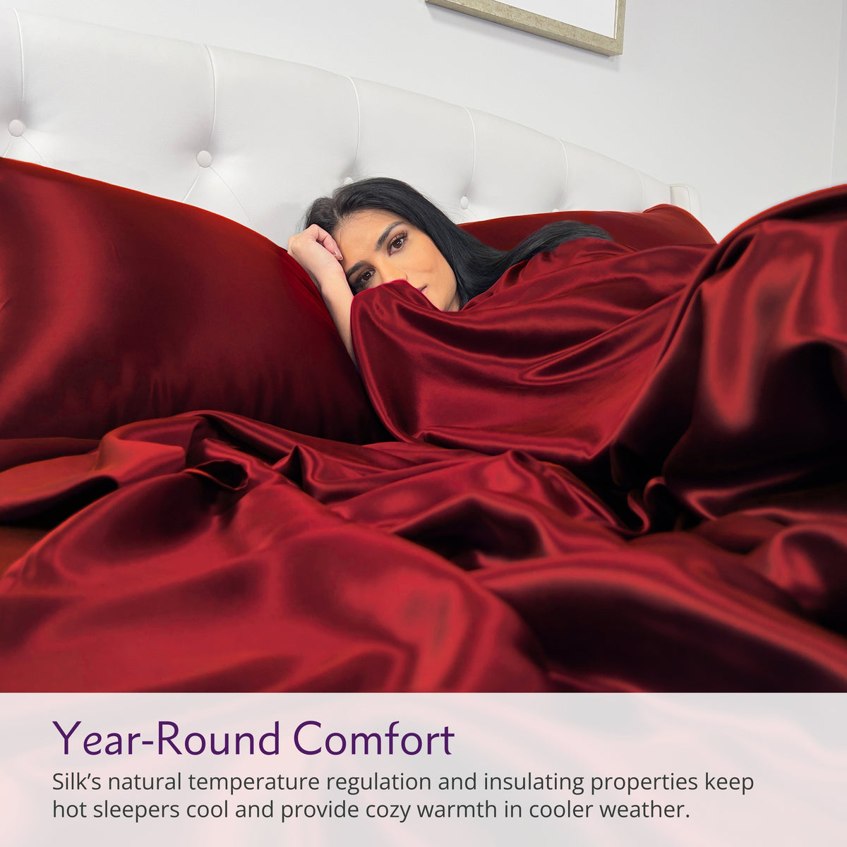 Woman lying under red silk sheets on a bed with text about year-round comfort.