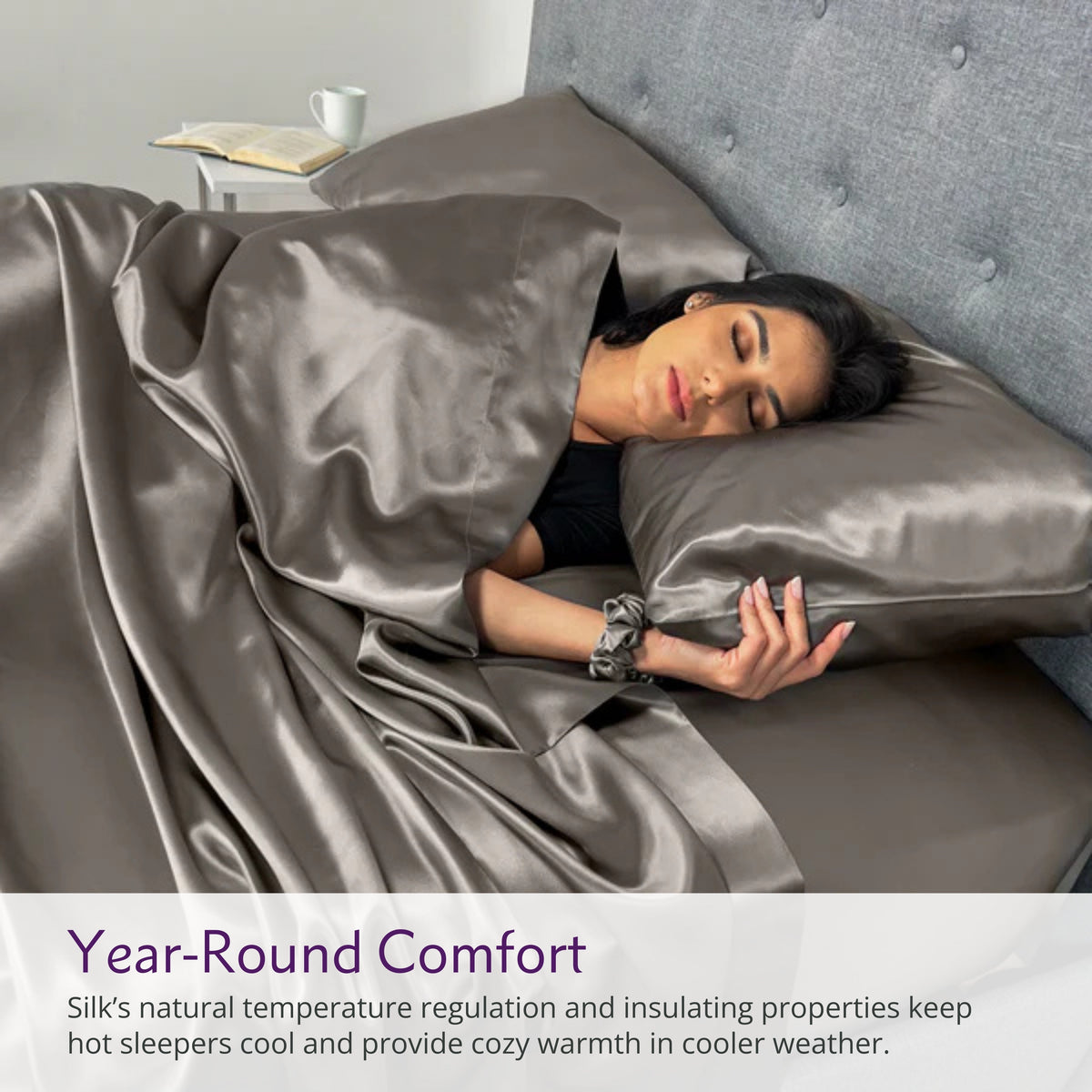 Woman sleeping on a gunmetal silk bed sheet set with matching pillow, showcasing ultimate comfort