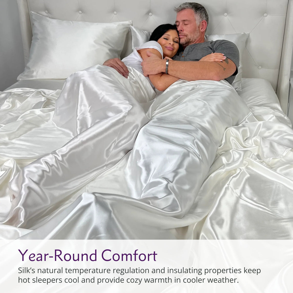 Couple cuddling on a bed with luxurious Ivory silk sheets, enjoying comfort and elegance
