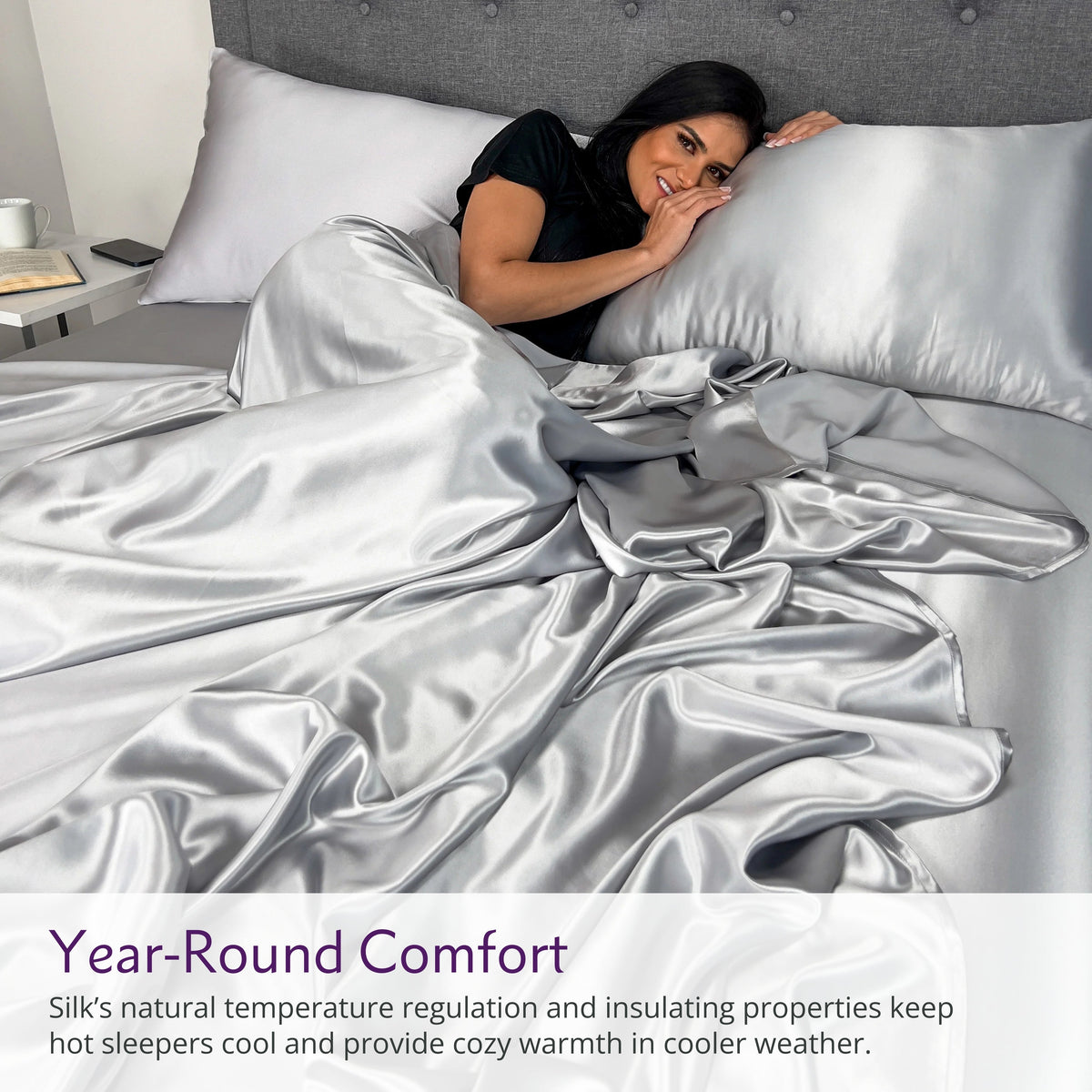 Woman sleeping on a silver silk bed sheet set with matching pillow, showcasing ultimate comfort