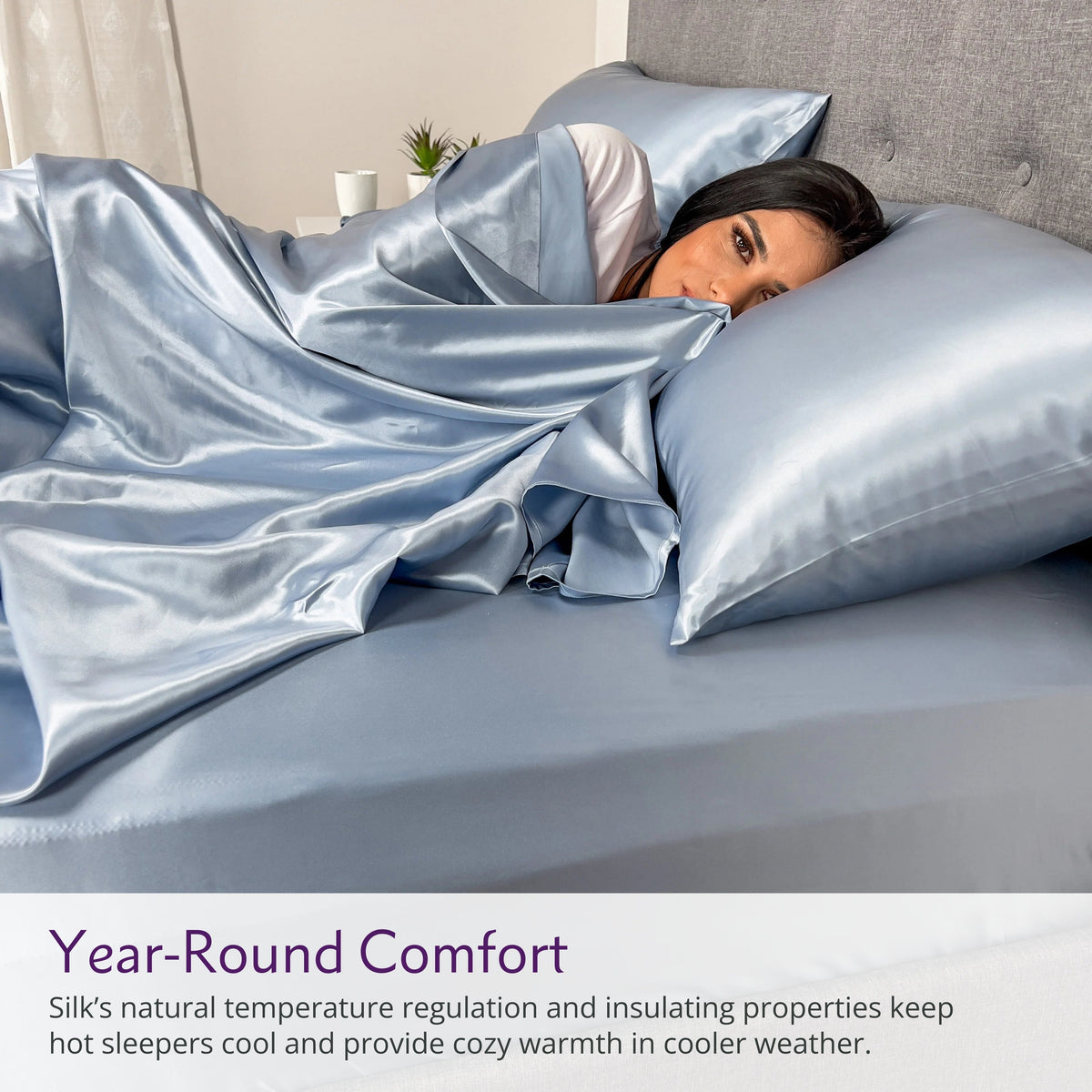 Woman peacefully sleeping on a silk bed sheet set with matching pillow, showcasing ultimate comfort