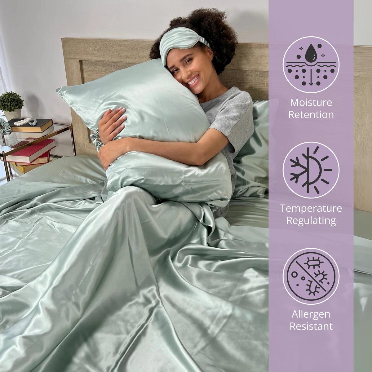 Woman sitting on bed, holding a sage silk pillow and enjoying the comfort of silk sheets