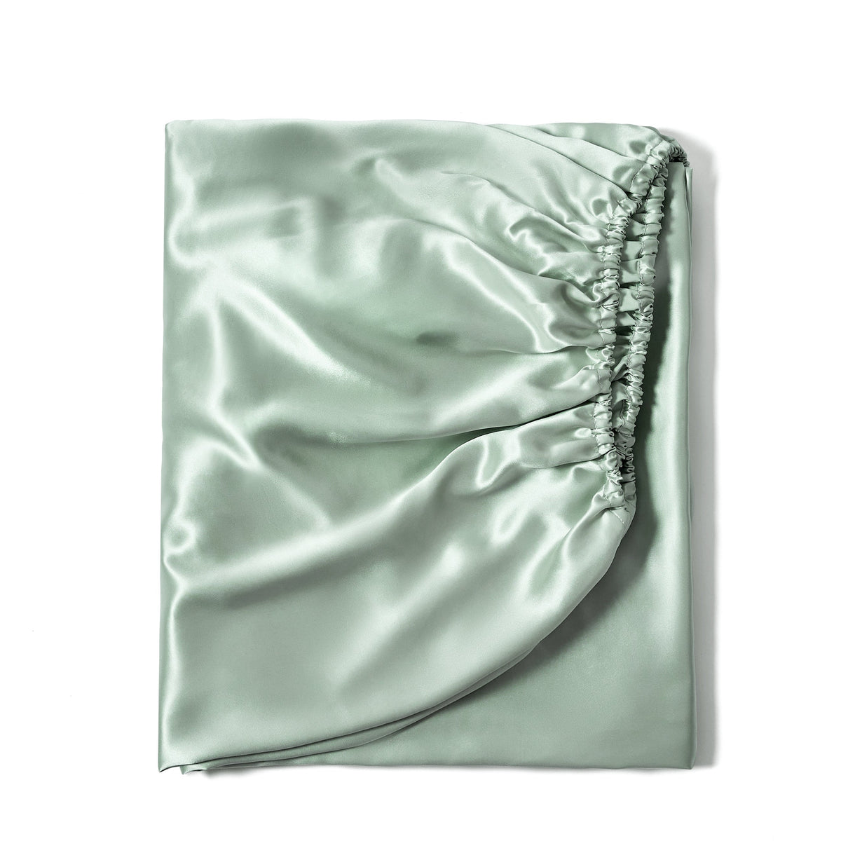 Luxurious 22 Momme silk fitted bed sheet in Sage, neatly folded for fabric display