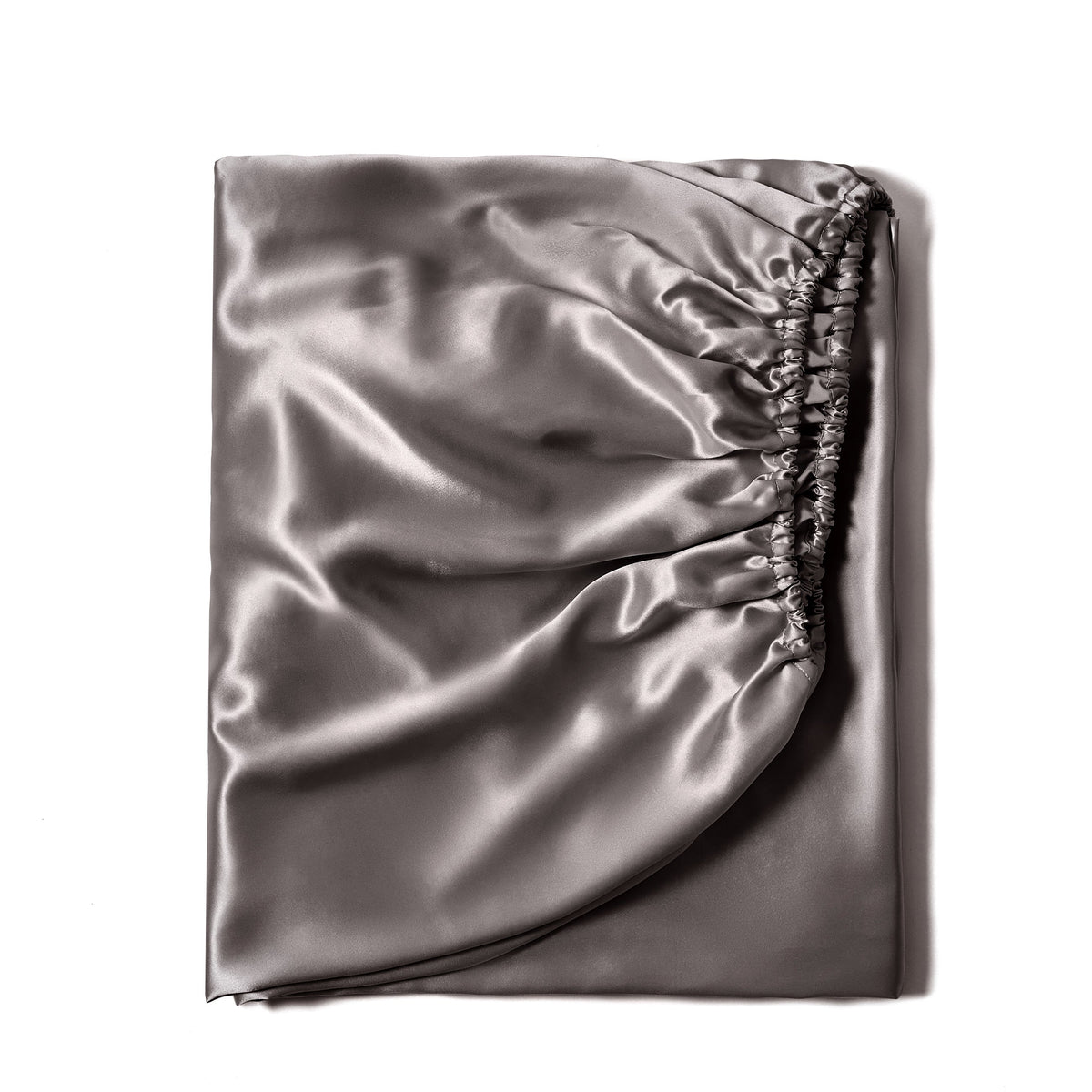 Luxurious 22 Momme silk fitted bed sheet in Gunmetal, neatly folded for fabric display