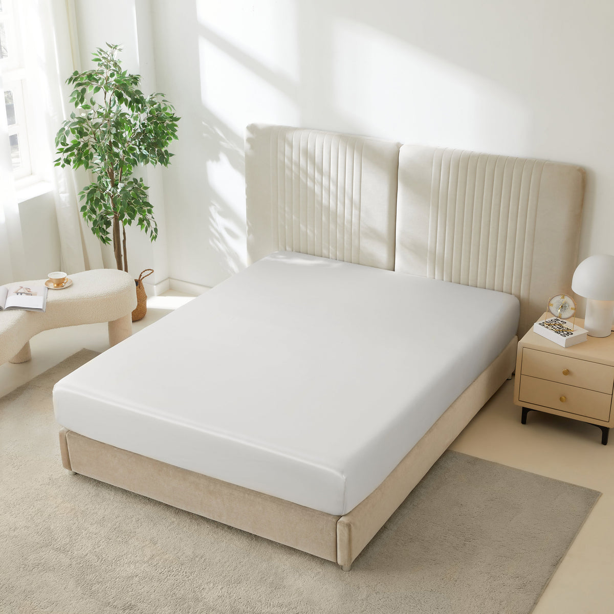 Mulberry Park Silks 22 Momme Silk Fitted Sheets in White on bed with upholstered headboard in a cozy bedroom setting