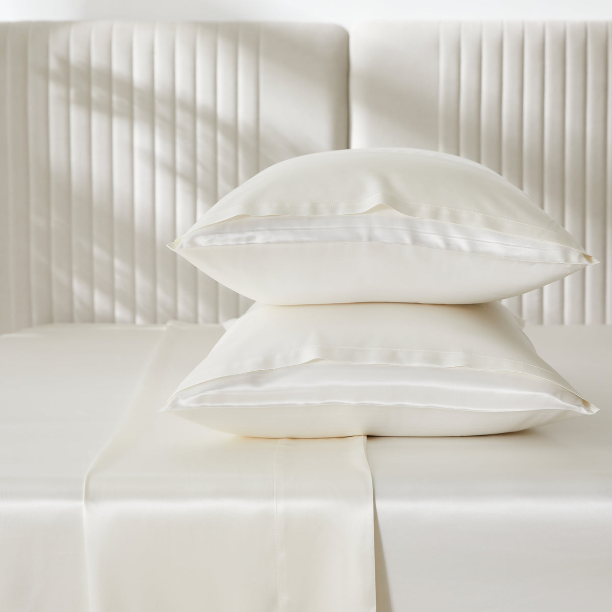 Close-up of smooth, ivory silk sheets made from 22 Momme 100% pure mulberry silk, OEKO-TEX certified