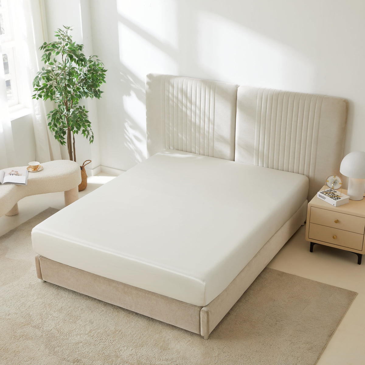 Mulberry Park Silks 22 Momme Silk Fitted Sheets in Ivory on bed with upholstered headboard in a cozy bedroom setting